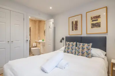 a bedroom with a large white bed with two pillows at Charming Central 1Bed Home in Chesterton