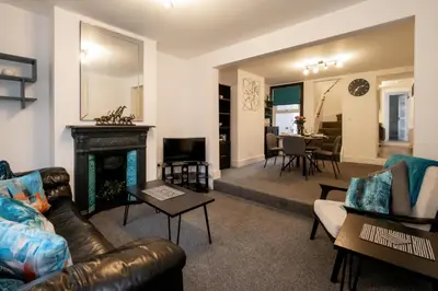 a living room with a couch and a fireplace at 21 Urban Road, sleeps 5 guests, Leiston, near Sizewell, Managed by Aldeburgh Coastal Cottages in Leiston