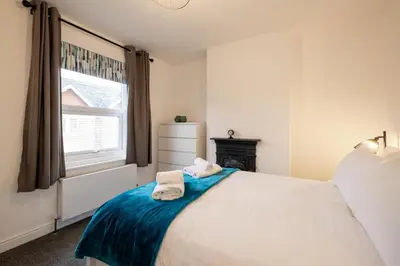 a bedroom with a bed with towels on it at 21 Urban Road, sleeps 5 guests, Leiston, near Sizewell, Managed by Aldeburgh Coastal Cottages in Leiston