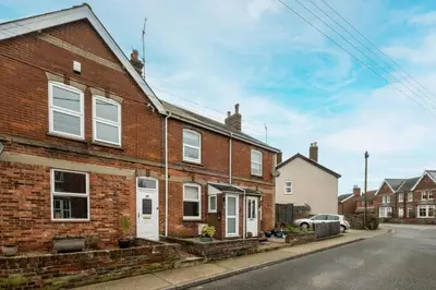 a brick house with white windows on a street at 21 Urban Road, sleeps 5 guests, Leiston, near Sizewell, Managed by Aldeburgh Coastal Cottages in Leiston