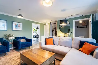 a living room with a couch and a table at Comfortable 3 bedroom Home Chelmsford Sleeps 5 - Pass the Keys in Chelmsford