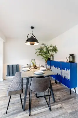 a dining room with a table and chairs at Comfortable 3 bedroom Home Chelmsford Sleeps 5 - Pass the Keys in Chelmsford