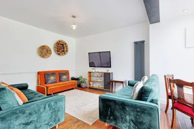 a living room with two couches and a tv at Spacious 4-Bedroom Home Near Station Seafront - Pass the Keys in Southend-on-Sea