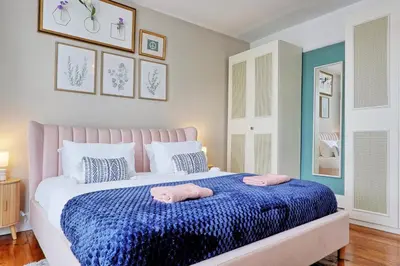 a bedroom with a bed with two towels on it at Spacious 4-Bedroom Home Near Station Seafront - Pass the Keys in Southend-on-Sea