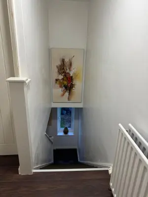a stairway with a painting on the wall at House in Colchester with parking in Colchester