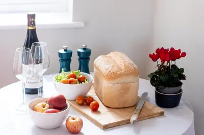 a table with a loaf of bread and a bowl of fruit at Oak Barn - Sleeps 3, Sweffling, near #Sizewell #Aldeburgh #Saxmundham - Managed by Aldeburgh Coastal Cottages in Rendham