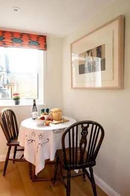 a table with a plate of food and two chairs at Oak Barn - Sleeps 3, Sweffling, near #Sizewell #Aldeburgh #Saxmundham - Managed by Aldeburgh Coastal Cottages in Rendham