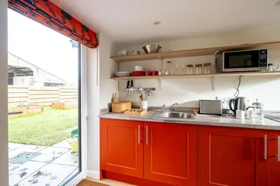 a kitchen with a sink and a microwave at Oak Barn - Sleeps 3, Sweffling, near #Sizewell #Aldeburgh #Saxmundham - Managed by Aldeburgh Coastal Cottages in Rendham