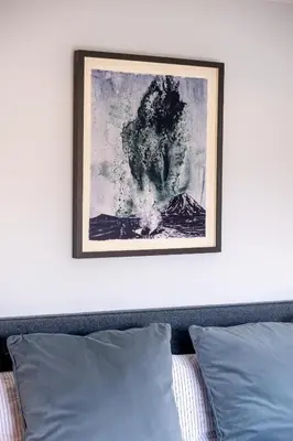 a picture above a bed with a picture on the wall at Oak Barn - Sleeps 3, Sweffling, near #Sizewell #Aldeburgh #Saxmundham - Managed by Aldeburgh Coastal Cottages in Rendham