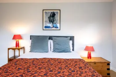 a bedroom with a large bed with two lamps at Oak Barn - Sleeps 3, Sweffling, near #Sizewell #Aldeburgh #Saxmundham - Managed by Aldeburgh Coastal Cottages in Rendham