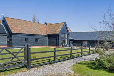 a wooden fence in front of a barn at 6 Bed in Ardleigh oc-b35089 in Ardleigh