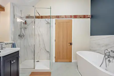 a bathroom with a tub and a sink and a shower at 6 Bed in Ardleigh oc-b35089 in Ardleigh