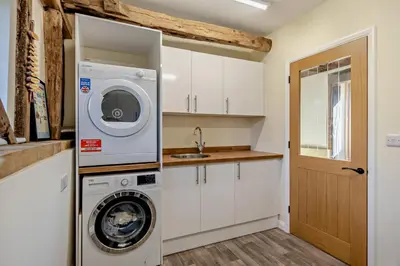 a kitchen with a washing machine and a sink at 6 Bed in Ardleigh oc-b35089 in Ardleigh