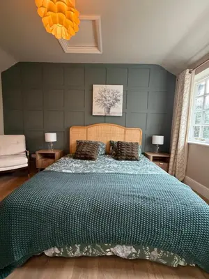 a bedroom with a large bed with a blue comforter at NEW Gorgeous Boutique Country Getaway in Tuddenham