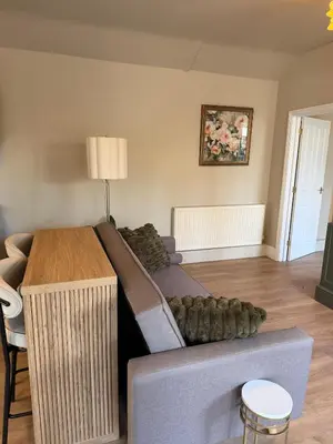 a living room with a couch and a table at NEW Gorgeous Boutique Country Getaway in Tuddenham