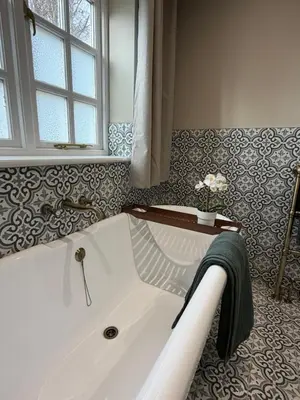 a white bath tub in a bathroom with a window at NEW Gorgeous Boutique Country Getaway in Tuddenham