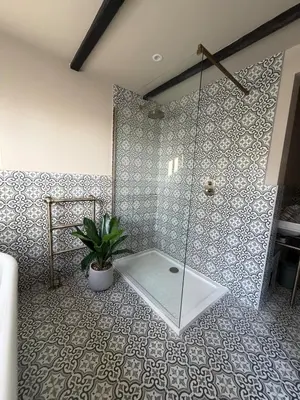 a bathroom with a glass shower with a plant at NEW Gorgeous Boutique Country Getaway in Tuddenham