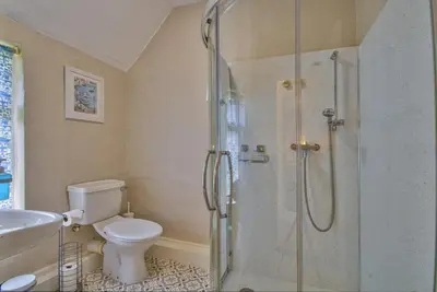 a bathroom with a shower and a toilet and a sink at Gardeners Cottage by Group Retreats in Hadleigh