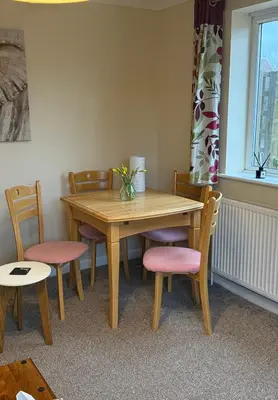a dining room table with chairs and a wooden table at The Wright One Bedroom Place To Stay in Kingsgate