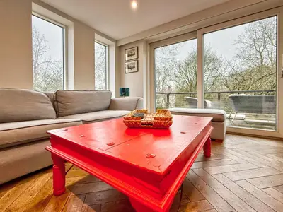 a living room with a couch and a red coffee table at Charming 6BDR home in the Essex Countryside in Stanford Rivers