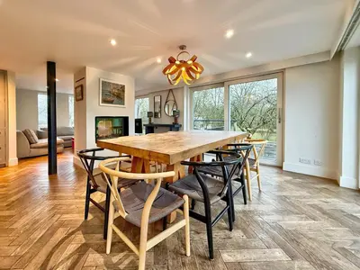 a dining room with a large wooden table and chairs at Charming 6BDR home in the Essex Countryside in Stanford Rivers