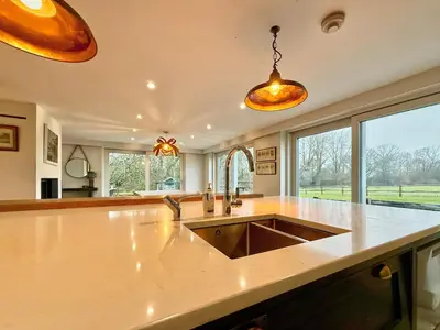 a large kitchen with a sink and a large window at Charming 6BDR home in the Essex Countryside in Stanford Rivers