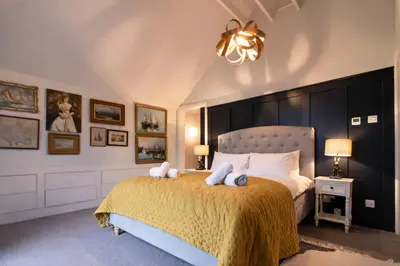 a bedroom with a bed with two stuffed animals on it at Charming 6BDR home in the Essex Countryside in Stanford Rivers