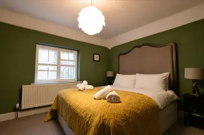 a bedroom with a bed with two stuffed animals on it at Charming 6BDR home in the Essex Countryside in Stanford Rivers