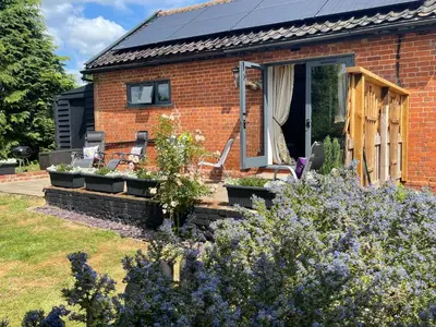 a brick house with a garden in front of it at The Tack Room at Green Farm Lodge in Stowmarket