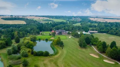 an aerial view of a golf course with a pond at Lakeside Lodge Golf and Country Club in Huntingdon