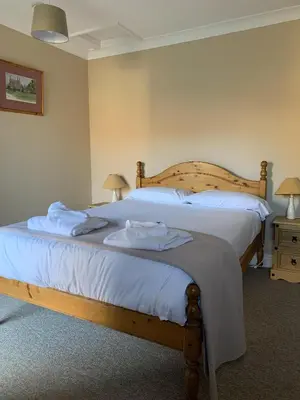 a bedroom with a bed with two towels on it at Lakeside Lodge Golf and Country Club in Huntingdon