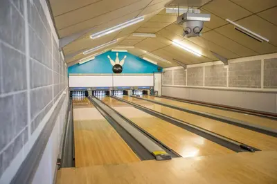 a bowling alley with a person with their arms in the air at Lakeside Lodge Golf and Country Club in Huntingdon