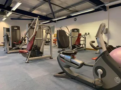 a gym with several tread machines in a room at Lakeside Lodge Golf and Country Club in Huntingdon