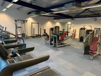 a gym with treadmills and machines in a room at Lakeside Lodge Golf and Country Club in Huntingdon