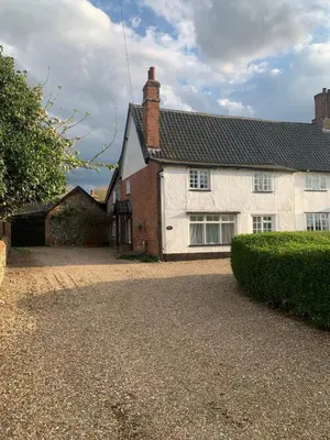 a white house with a driveway in front of it at Dog-friendly rural retreat in Bury Saint Edmunds