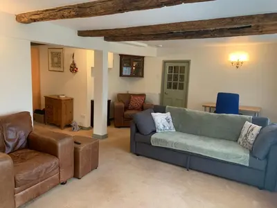 a living room with a couch and chairs and a table at Dog-friendly rural retreat in Bury Saint Edmunds