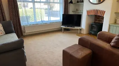 a living room with a couch and a flat screen tv at Dog-friendly rural retreat in Bury Saint Edmunds