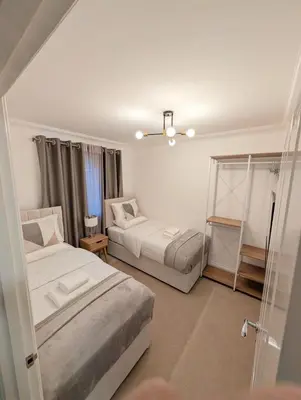 a bedroom with two beds and a window at Modern 3BR House I Garden I Cambridge I Parking x 2