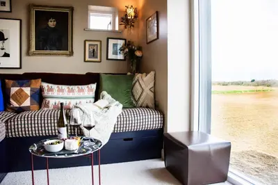 a living room with a couch and a table at The Barn at Manor Farm in Great Glemham