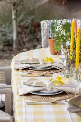 a table with a yellow and white checkered table cloth at The Barn at Manor Farm in Great Glemham
