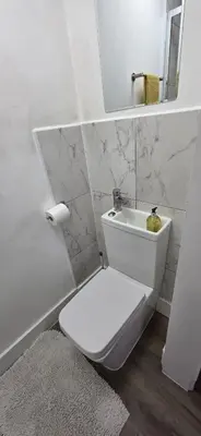 a white bathroom with a toilet and a sink at Great En-suite room, room 4 in Ipswich