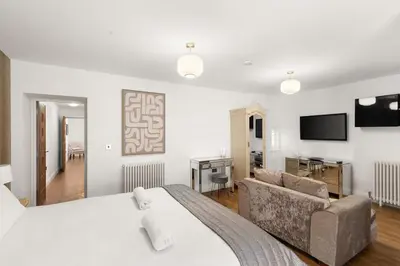 a hotel room with a bed and a couch at Modern 3BR Basement Flat with Outdoor Terrace in Southend-on-Sea