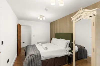 a bedroom with a large bed in a room at Modern 3BR Basement Flat with Outdoor Terrace in Southend-on-Sea
