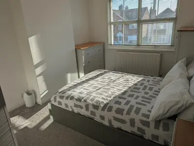 a small bedroom with a bed and a window at Walton holiday home in Walton-on-the-Naze