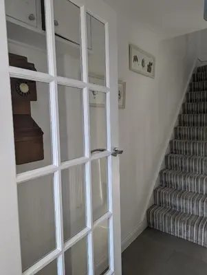 a glass door in a room with a staircase at Walton holiday home in Walton-on-the-Naze