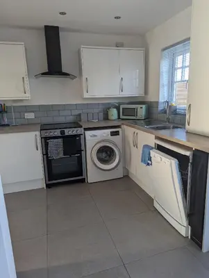 a kitchen with a washing machine and a dishwasher at Walton holiday home in Walton-on-the-Naze