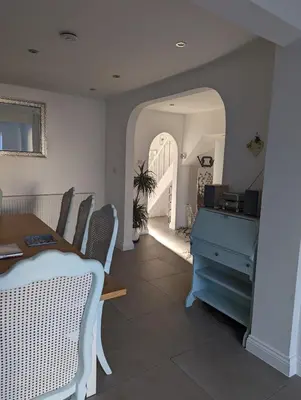 a dining room with a table and a blue dresser at Walton holiday home in Walton-on-the-Naze