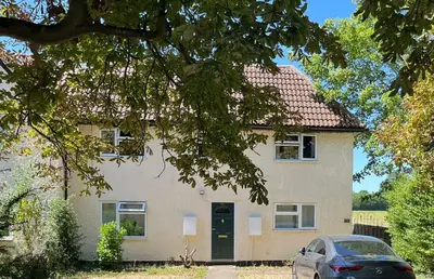 a house with a car parked in front of it at Comfy 1 bed in the idyllic village of Hemingford Grey in Hemingford Grey