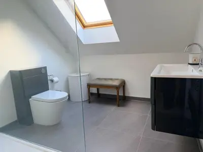 a bathroom with a toilet and a sink at Turnpike Red Lodge in Bury Saint Edmunds