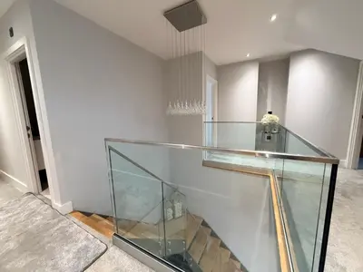 a glass case in a room with a staircase at Turnpike Red Lodge in Bury Saint Edmunds